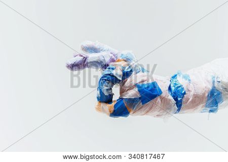 Big Plastic Hand Made Of Garbage Isolated On White Studio Background. The Result Of Polymers Overusi