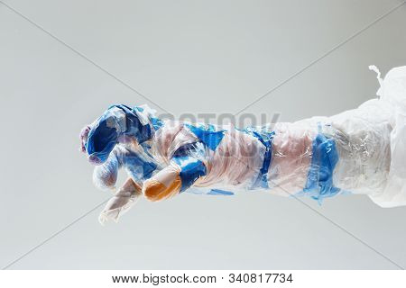 Big Plastic Hand Made Of Garbage Isolated On White Studio Background. The Result Of Polymers Overusi