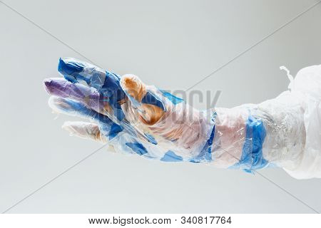 Big Plastic Hand Made Of Garbage Isolated On White Studio Background. The Result Of Polymers Overusi