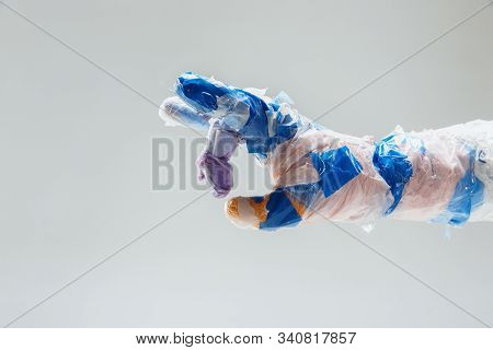Big Plastic Hand Made Of Garbage Isolated On White Studio Background. The Result Of Polymers Overusi