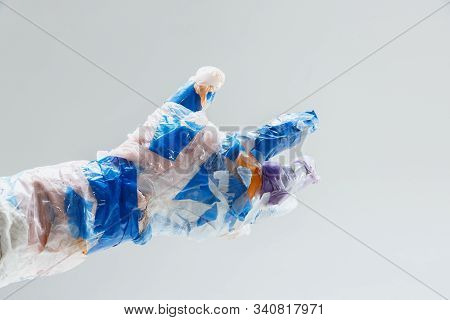 Big Plastic Hand Made Of Garbage Isolated On White Studio Background. The Result Of Polymers Overusi