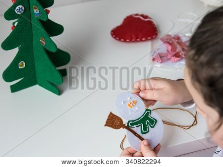 The Hand Of The Child Make Snowman For Christmas Greeting Card. Xmas Toys Decoration For Greeting Ca