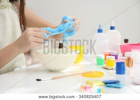 Little Girl Making Diy Slime Toy At Table, Closeup