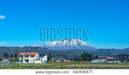 Snow Capped Mount Iwate With Clear Blue Sky Natural Background, Beauty Townscape Of Takizawa And Shi