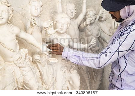 Tovp, Mayapur. West Bengal, India. - Dec 16, 2019. Artisan Working On Sculpture On The Building Of T