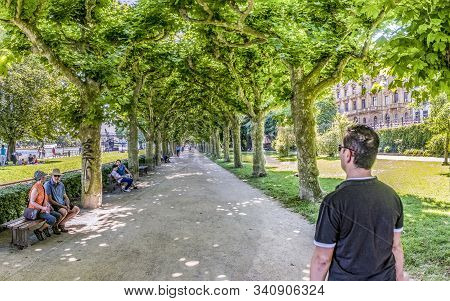 Frankfurt, Germany - July 10, 2016: People Relax At The Benches In The Area Klein Nizza In Frankfurt