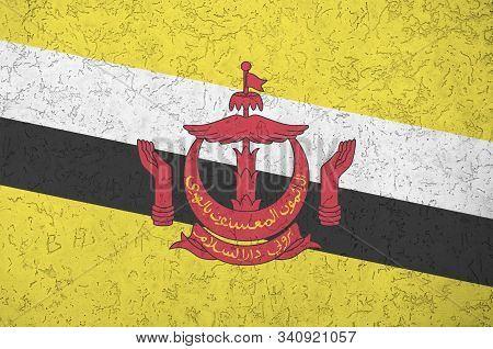 Brunei Darussalam Flag Depicted In Bright Paint Colors On Old Relief Plastering Wall. Textured Banne
