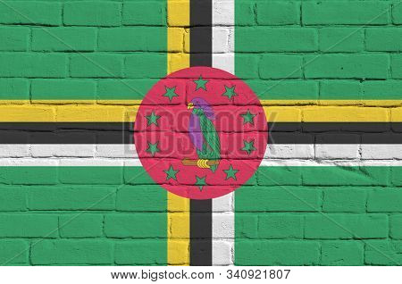 Dominica Flag Depicted In Paint Colors On Old Brick Wall. Textured Banner On Big Brick Wall Masonry 