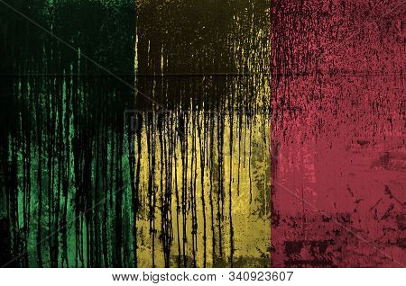 Mali Flag Depicted In Paint Colors On Old And Dirty Oil Barrel Wall Closeup. Textured Banner On Roug