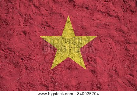 Vietnam Flag Depicted In Bright Paint Colors On Old Relief Plastering Wall. Textured Banner On Rough