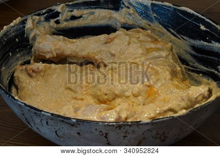 Cooking Chicken In White Sauce, In The Marinade. Smearing Dark Hands With Mayonnaise Or Seasonings C