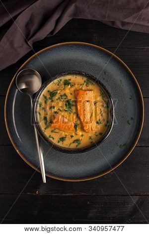 Salmon Creame Soupe In Bowl With Spoon On Wooden Table