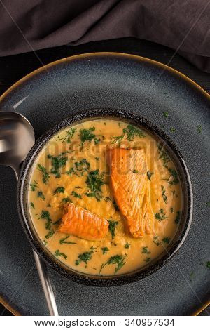 Salmon Creame Soupe In Bowl With Spoon On Wooden Table
