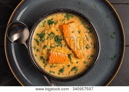 Salmon Creame Soupe In Bowl With Spoon On Wooden Table