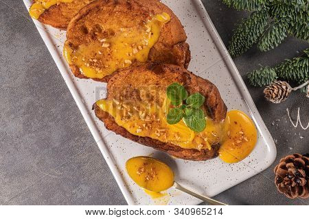 Traditional Christmas Rabanadas With Egg Yolk Cream And Cinnamon. Spanish Torrijas Close Up On The C