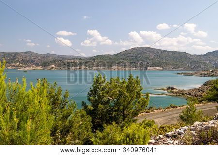 Scenic View At The Gadoura Water Reservoir On Rhodes Island, Greece With Blue And Turquoise Water An