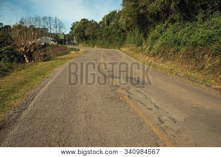 Bucolic Rural Landscape With Asphalt Road Going Through The Hill And Woods In A Cloudy Day Near Bent