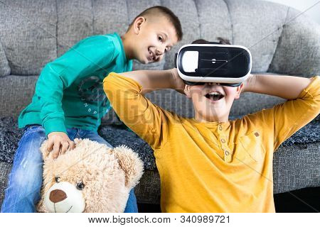 Cute, Little Boy Having Fun With Vr Headset With His Brother Next To Him And Teddy Bear Toy. Kids An