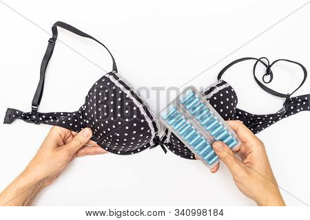 Hands Holding Bra And Blister Of Pills For Mastopathy Treatment Therapy, Mammalogy Concept.