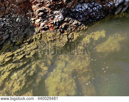 Geodesy. Stone Texture. The Rock Is Brown And Red. Mineral Background. Design From Natural Materials