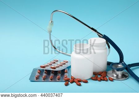 Pills And Stethoscope On Turquoise Background, Space For Text. Anemia Treatment
