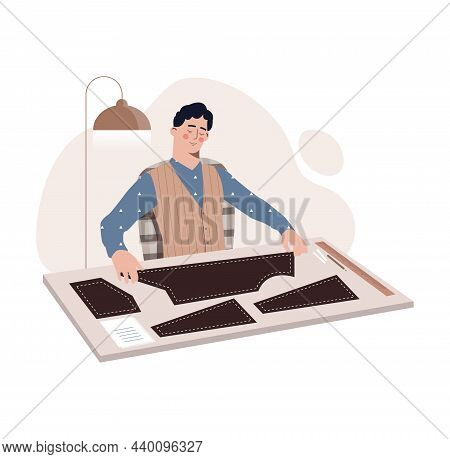 Fashion Designer Concept. Young Man In Stylish Suit Sitting At Table And Making Patterns For Sewing 