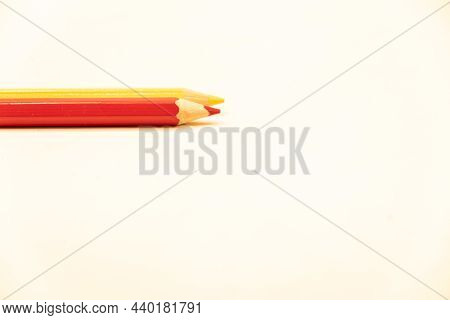 Red And Yellow Coloring Pencils On A White Background