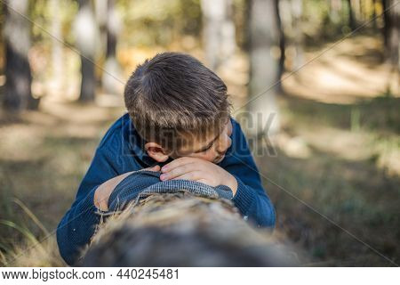 Boy Backpacker Sleeping On The Log  In Nature , Relax Time On Holiday Concept Travel,selective And S