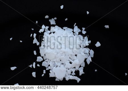 Potassium Hydroxide Flake Dangerous Chemical On Black Background