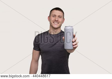 Sportman Showing Tin Can Drink. Energy Drink For Sport. Man With Can In Hands.