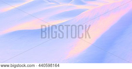 Abstract Surreal Image In Neon Pink, Blue And Golden Colors Undulating Slopes Of Snow Drifts.