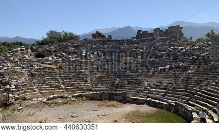 Ancient Stones Of The Excavated Historic City. Ruins Of An Ancient Amphitheater. Roman Amphitheater