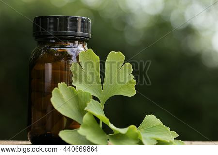 Ginkgo Biloba Tablets.alternative Medicine And Homeopathy. Brown Jar With Pills , Ginkgo Biloba Leav