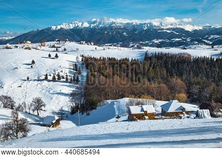 Picturesque Alpine Village And Beautiful Winter Scenery With Snowy Mountains In Background, Pestera 