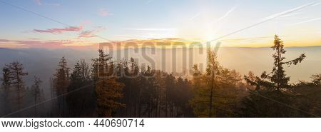 Autumn Czech Landscape With Misty Fog And Trees Silhouette At Morning Sunrise. Panoramic View From W