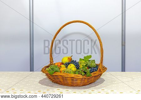 Vicker Basket Of Plastic Fruits At Dining Table
