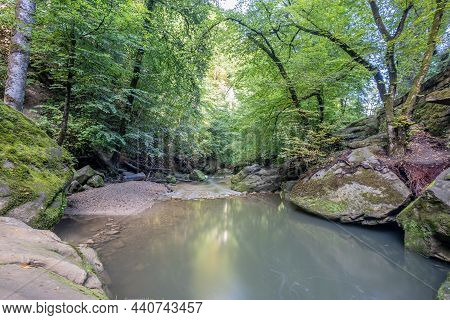 Crystal Clear Calcareous Water In The Black Ernz River Between Huge Sandstone Stones Between Trees A