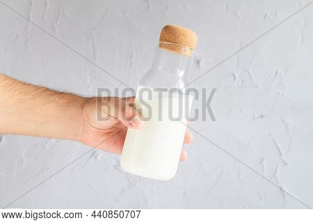 Man Holding Bottle Of Homemade Yogurt, Kefir, Buttermilk Or Natural Fermented Milk