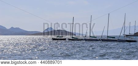 Blue Sea Sparkling In The Sun. Beautiful Coast With Islands, Mountains And Yachts