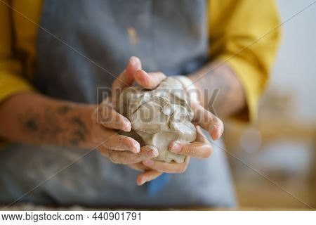 Female Potter Artist Molding Raw Clay. Closeup Of Woman Ceramist In Dirty Apron Prepare For Shaping 