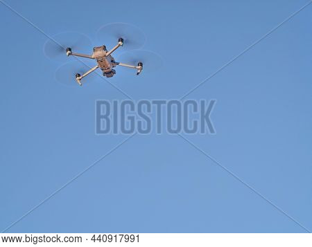 Grover, CO, USA - November 22, 2021: Mavic 3, an advanced, foldable consumer drone by DJI is flying against blue sky.