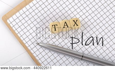 Tax Plan Text Concept Written On Wooden Cubes Blocks And Notebook