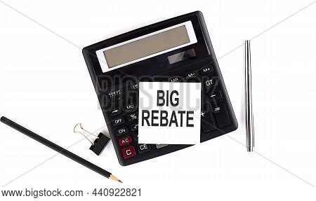 Big Rebate Text On Sticker On Calculator With Pen,pencil On White Background