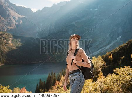 Wanderlust And Travel Concept. Stylish Traveler Girl In Hat Looking At Map, Exploring Woods. Young W