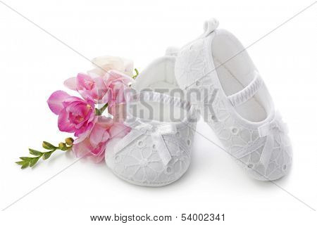 Baby girl shoes with pink flowers isolated on white background