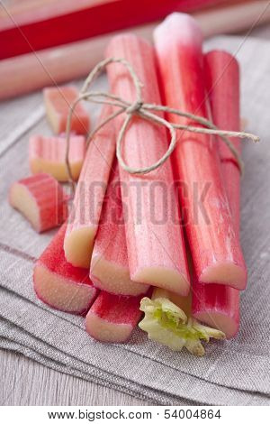Bunch of fresh rhubarb on wooden background