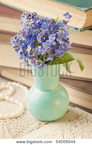 Forget me not flowers and old books