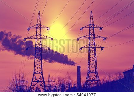 High voltage electricity transmissions line on a sunset with a retro effect