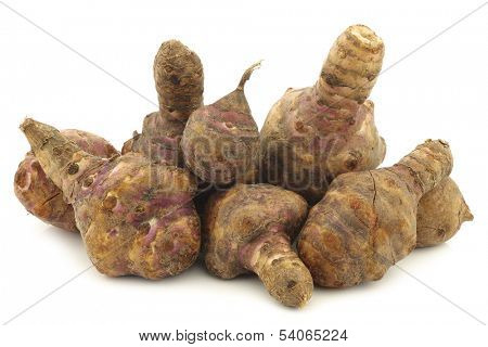 bunch of topinambur roots (helianthus tuberosus) on a white background