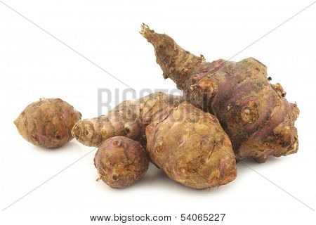 bunch of topinambur roots (helianthus tuberosus) on a white background